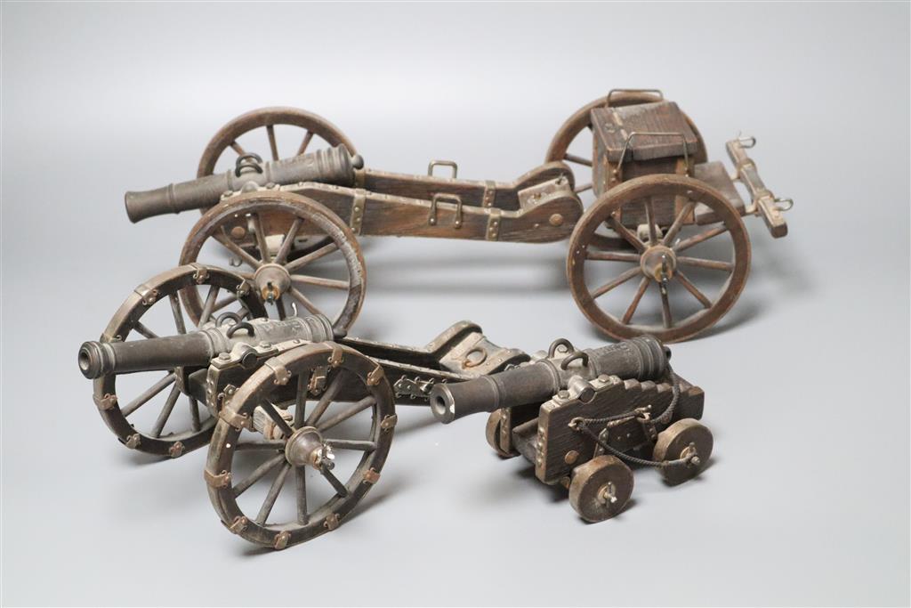 Three oak and wrought iron models of historic cannons, longest 39cm